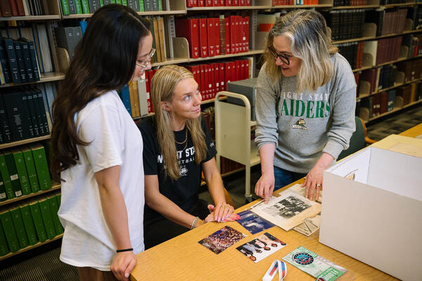 staff member in the archives helping students