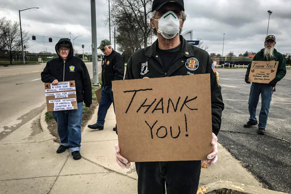 Men holding thank you signs