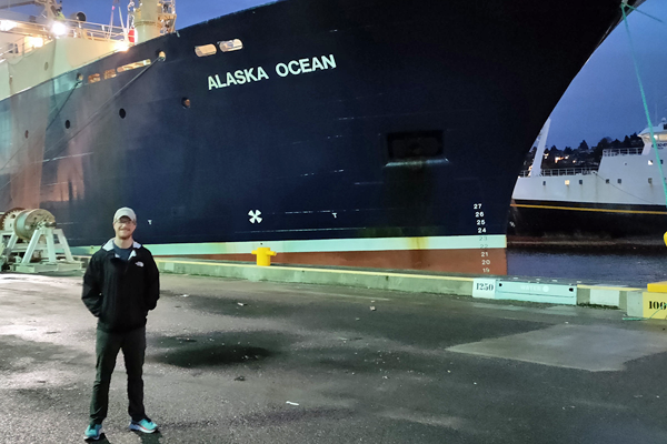 Ben Strang in front of ship