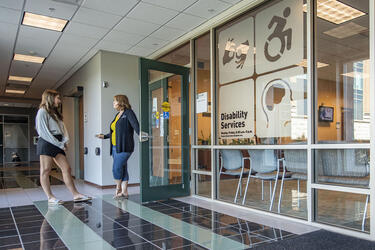 photo of a student and staff member at the office of disability services