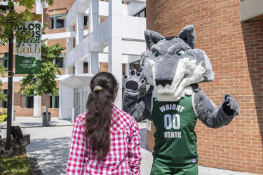 photo of a student and Rowdy high-fiving