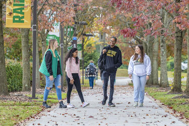students walking outside on campus