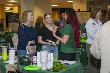 photo of a student and staff member at an open house