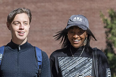 two students walking together on campus