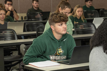 students in a classroom listening 
