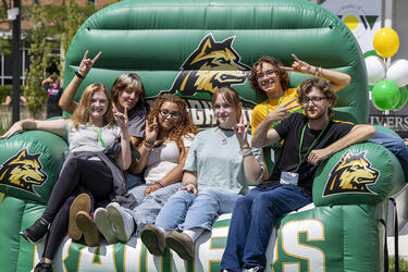 a group of students sitting in a green inflatable chair