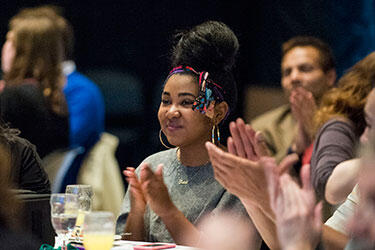 photo of a people applauding at a ceremony
