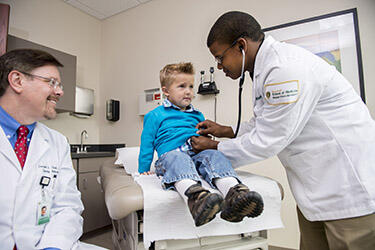 photo of a medical student and a patient