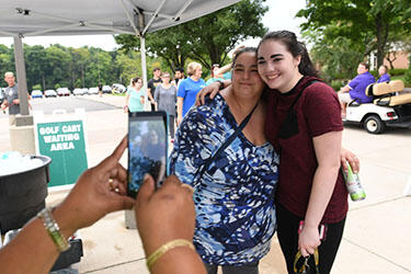 photo of a student and parent on campus