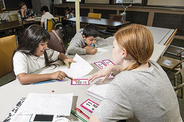 photo of a student teacher and two young students