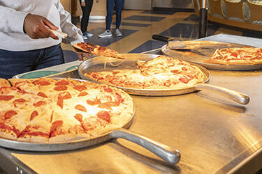 photo of a student and pizza in union market