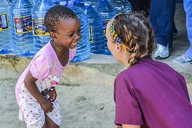 photo of a student and child on a study abroad trip