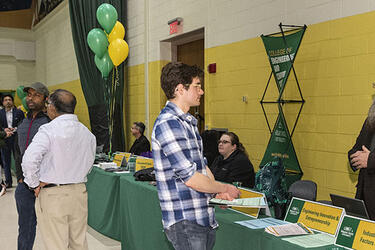 photo of a prospective students, faculty, and staff at open house