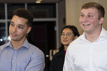 photo of three people at an event on campus