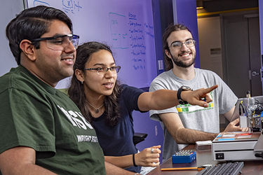 photo of two students working together in a lab