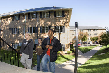 photo of students walking near the woods 