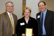 Political Science professor Donna Schlagheck with Provost David Hopkins, left, and Douglas Nord, Director of the University Cent