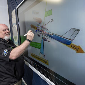 aviation instructor writing on whiteboard