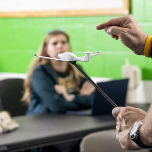 a student and instructor in an aviation classroom