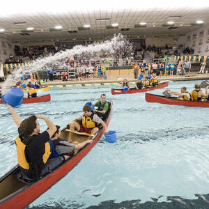 photo of students doing kayaking in the swimming pool inside the campus 
