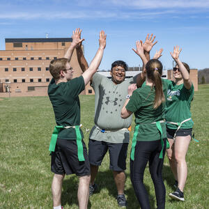 photo of students doing high-five 