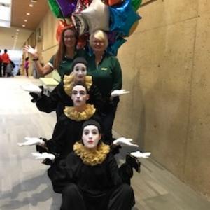 Three mimes and two staff members plus balloons