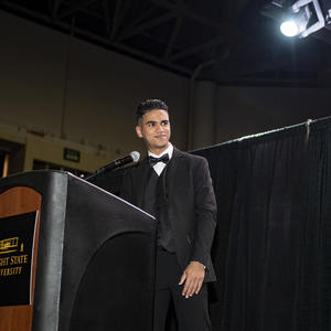 photo of a student speaking at an event on campus