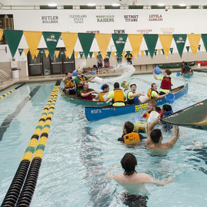 photo of students in boats in the pool