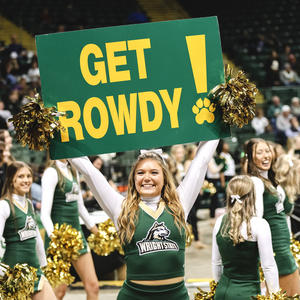 Cheerleader pumping up crowd with Get Rowdy Sign